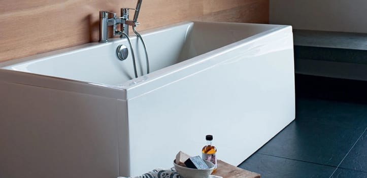A standard bath fitted to the wall with three sides covered in bath panels.